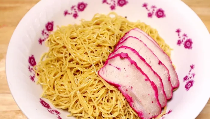 Add barbecue pork (see separate recipe), fried shallots, onion, and cilantro to the noodles.