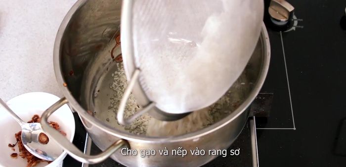 Add the rice to the pot with the fragrant oil and stir-fry until opaque.