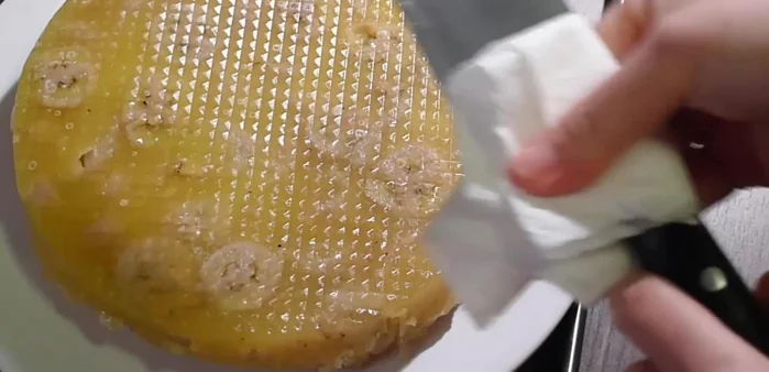 Slice the cake (greasing the knife between each slice) and transfer to a serving plate.