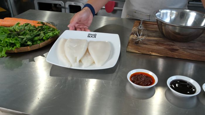 Combine chili sauce, oyster sauce, sugar, and fish sauce in a bowl to create the marinade. Mix well. (Note: You don't need a lot of marinade; you want to taste the squid itself.)