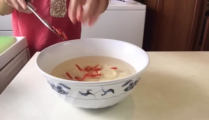 Add 4 sliced Thai chilies (optional).