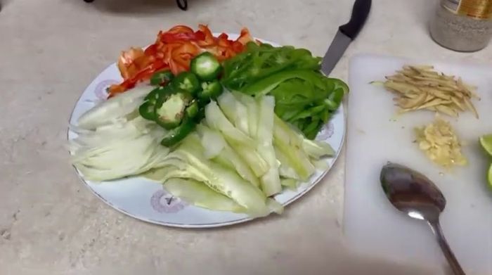 Prepare the salad ingredients: slice cucumber, onion, and chilies.