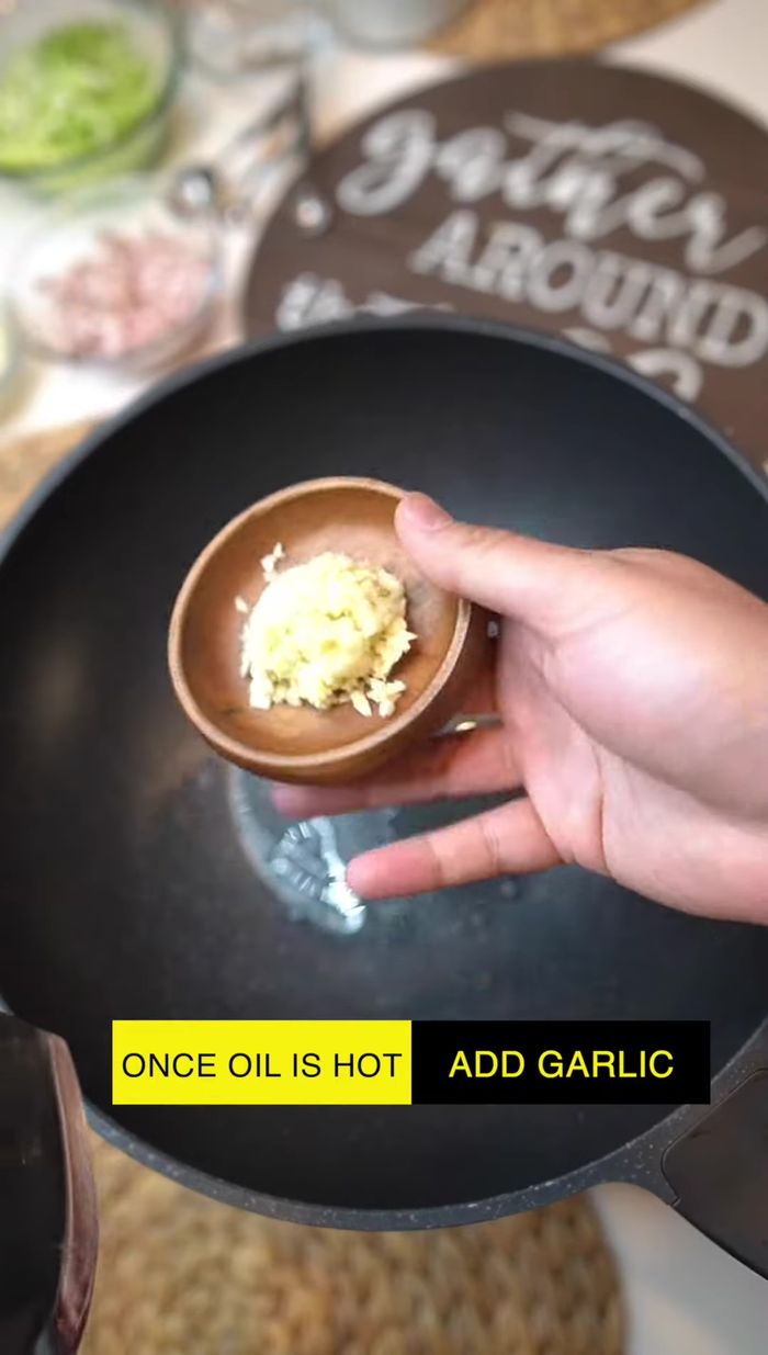 Add minced garlic to the hot oil and stir until fragrant.