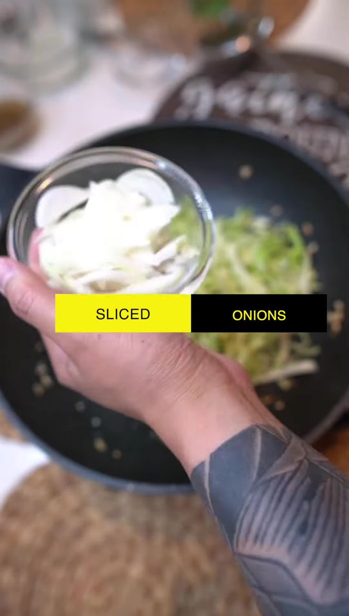 Add sliced cabbage and onions. Stir-fry for 2-3 minutes.
