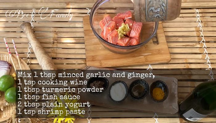 Add the pounded ginger and garlic, turmeric powder, fish sauce, yogurt, and shrimp paste to the salmon. Mix well.