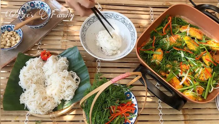 Serve the fried fish with fresh noodles, sliced dill, peanuts, and shrimp paste. Garnish with herbs.