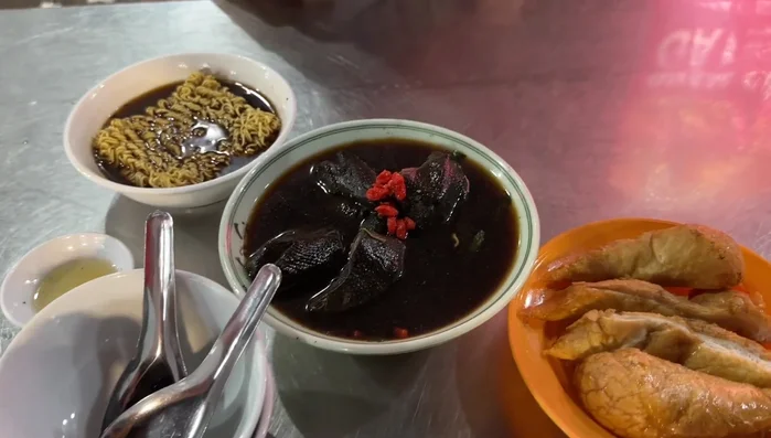 Prepare the black chicken. (Note: The video doesn't detail preparation, but assumes the chicken is already cleaned and ready for cooking)