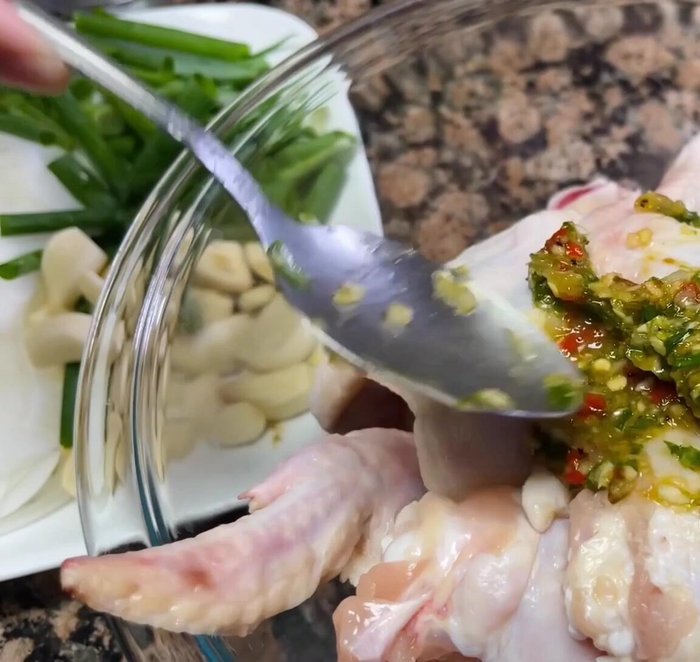 Add the marinade to the chicken wings and toss to coat thoroughly. Ensure each wing is well-soaked.