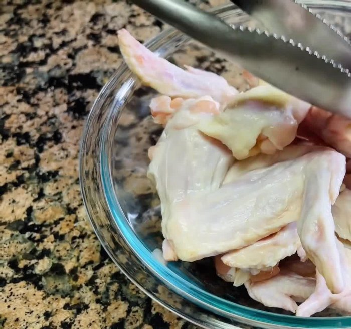 Clean and thoroughly dry the chicken wings. You can leave them whole or cut them into smaller pieces.