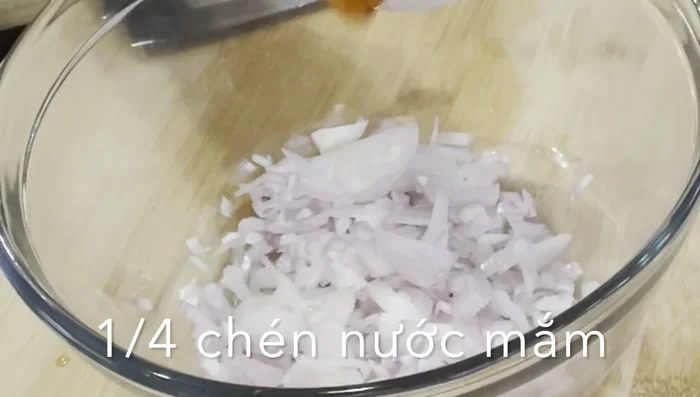 Chop a medium-sized shallot. Mix it with 1/4 cup fish sauce, shredded ginger, 1 teaspoon black pepper, 2 teaspoons mushroom seasoning, and 1 teaspoon salt.
