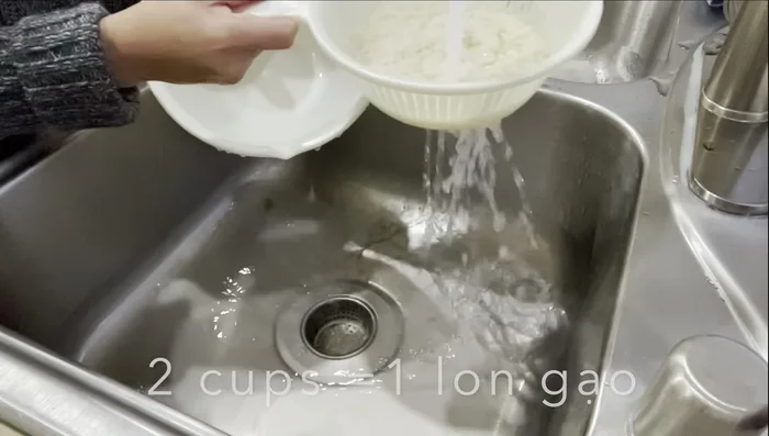 Bring 12 cups of water to a boil in a pot. Add 2 cups of rice and cook until slightly golden brown.