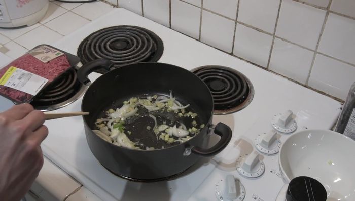 Once the lemongrass softens (about 5 minutes), add ground beef and break it apart. Stir in fish sauce and black pepper.