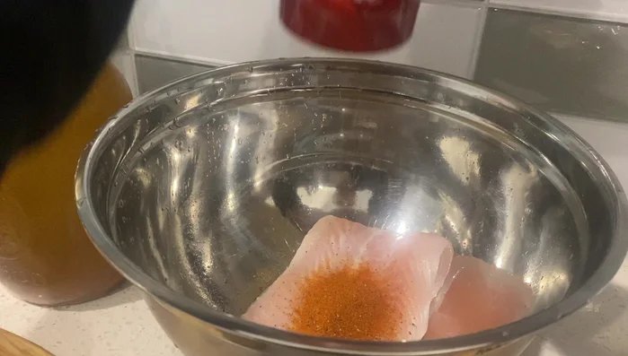 Marinate the basa filet with paprika, black pepper, fish sauce, sugar, and salt. (Rub it around)