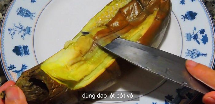 Remove the cooked eggplant from the microwave, peel off the skin, and scrape the flesh.