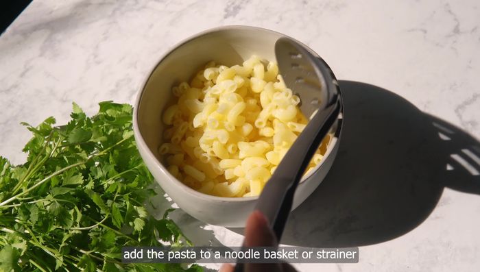 To serve, add pasta to bowls (use a noodle basket to warm it in the broth). Divide ribs and carrots between bowls. Ladle broth over. Top with herbs and serve.