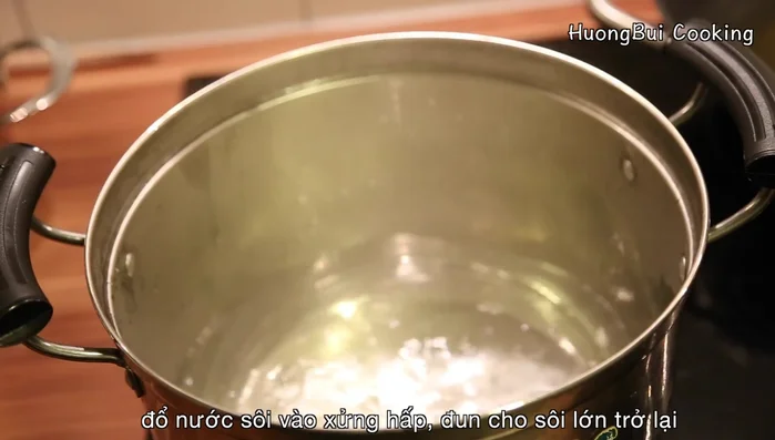 Steam the rice mixture over high heat for 30 minutes, fluffing the rice halfway through to ensure even cooking. Wipe the steamer lid to prevent water droplets from falling onto the rice.