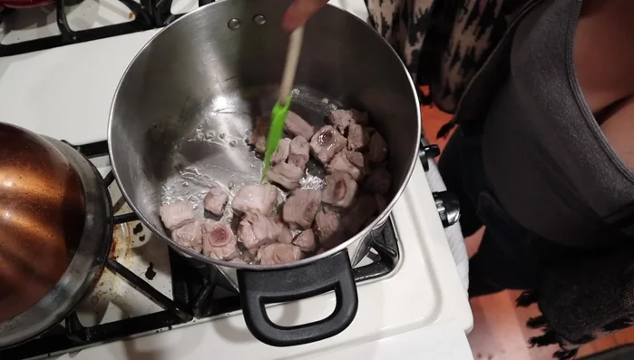 Add the marinated spareribs to the pot.