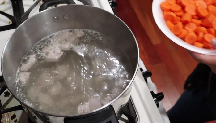 After about 15 minutes of simmering, add the carrots and potatoes.