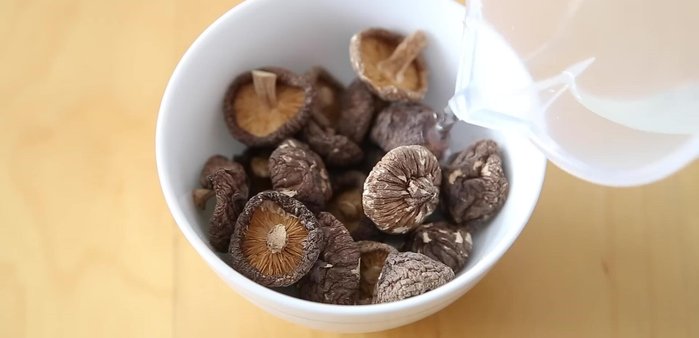 While the chicken simmers, soak shii mushrooms in water to soften.