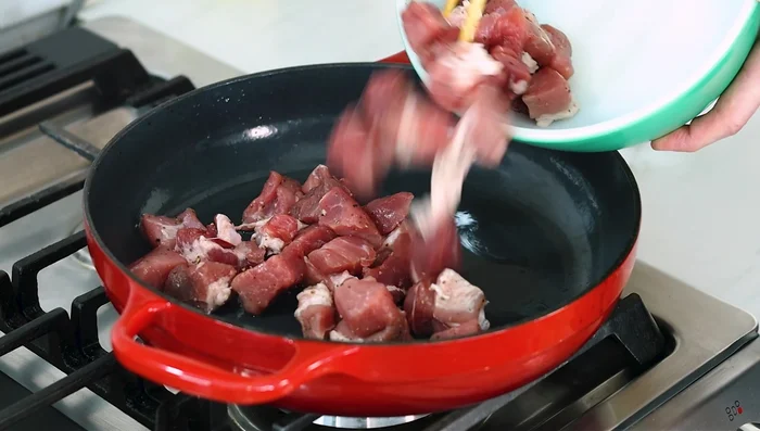 Heat oil in a cast iron pan over medium-high heat. Brown pork pieces on all sides, working in batches if necessary.