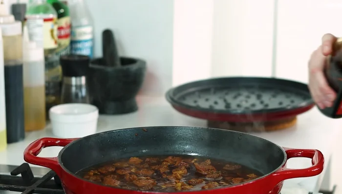 After 35 minutes of braising, season the pork with soy sauce and fish sauce. Let it reduce uncovered until sauce thickens.