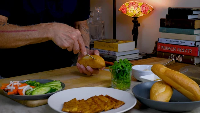 Assemble the banh mi: Spread vegan mayonnaise on both sides of the bread. Add the marinated tofu, pickled vegetables, cucumber, jalapeno, and cilantro.