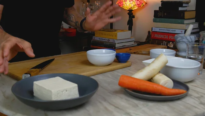 Cut the tofu into 1/4-inch thick strips and score the tofu lightly, being careful not to cut all the way through.