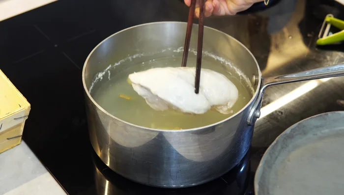 Drain soaked noodles and set aside. Once chicken is cooked, remove from pot, let cool, and shred into thin strips.