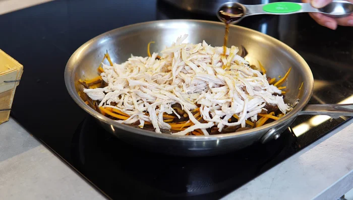 Add shredded chicken, bún, and fish sauce; sauté for another minute. Add chicken cooking liquid as needed to prevent dryness. If using pre-cooked chicken, substitute water or broth.