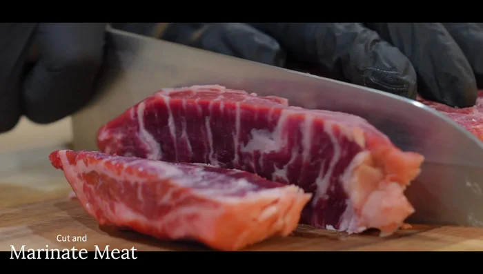Cut beef into thick slices, then cubes (or thin slices). Marinate with minced garlic, dark soy sauce, oyster sauce, light soy sauce, cooking oil, corn starch, sugar, and black pepper for 30 minutes.
