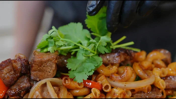 Serve: Transfer to a serving plate. Garnish with cilantro. Serve with chili sauce for dipping (optional).