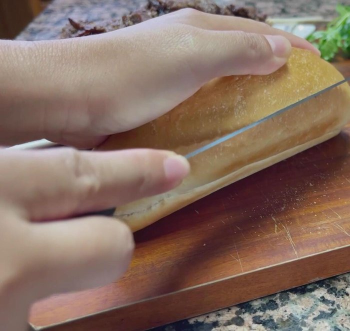 Layer the lemongrass beef generously inside the baguette.