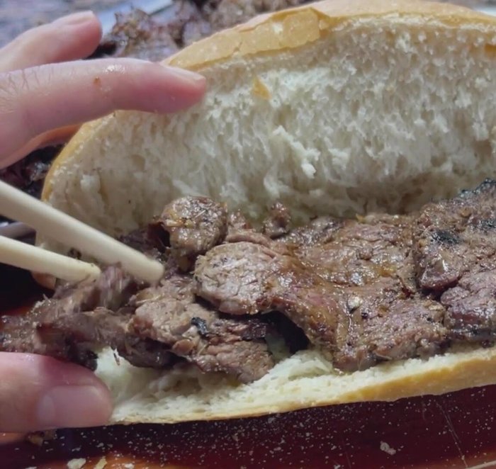 Add jalapenos, cucumbers, fermented daikons and carrots, and cilantro to the sandwich.
