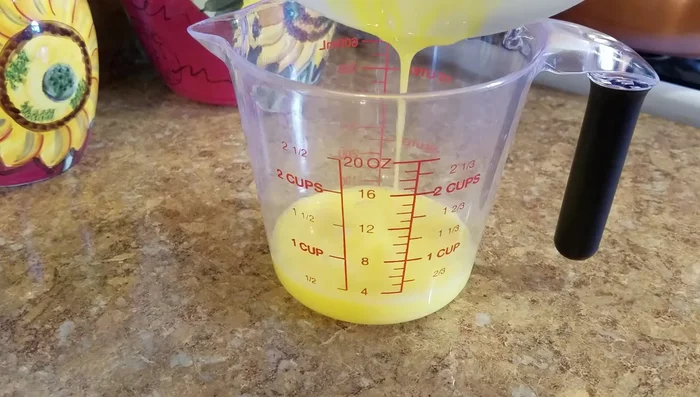 Beat two eggs in a bowl and pour into a measuring cup.