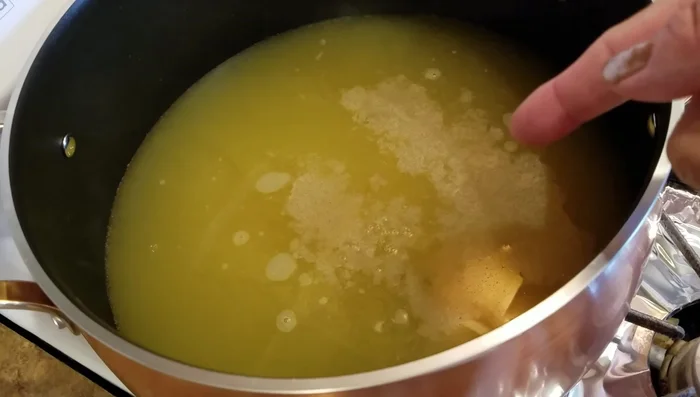 Add chicken seasoning, white pepper, sesame oil, and fish sauce to the boiling soup. Stir well.