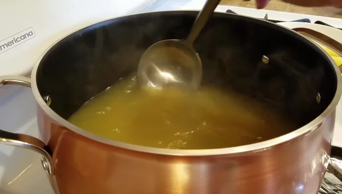 Add crab meat, asparagus (including reserved liquid), and quail eggs to the soup. Stir gently.