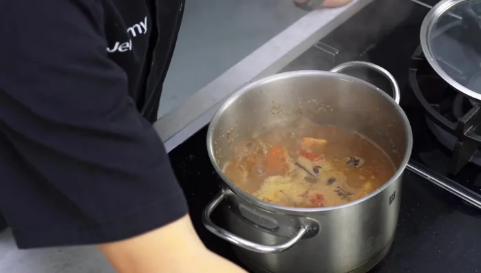Season with fish sauce, salt, and sugar. Simmer for at least 1.5-2 hours, or up to 5-6 hours for a richer flavor. Add carrots and potatoes during the last 30 minutes of cooking.