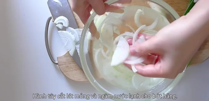 Thinly slice a shallot and soak in cold water to remove strong odor. Chop spring onion leaves and lightly smash the white stems.