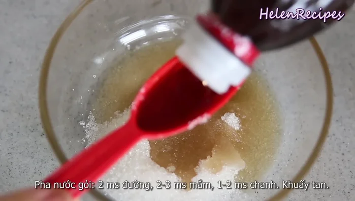 Make the dressing: In a bowl, mix sugar, fish sauce, and lime juice until sugar dissolves. Add garlic and chili. The dressing should balance sweet, sour, and savory.
