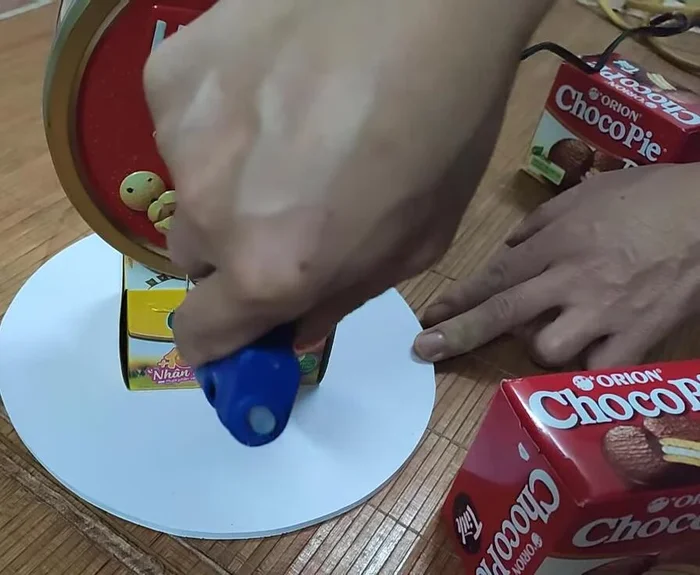 Arrange candies neatly on the base. If using less candy, styrofoam or a box can be used as a base.