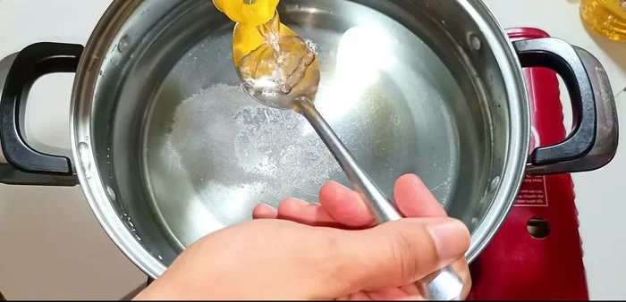 Boil pig's hands: Boil pig's hands in water with lemongrass, ginger, and green onions for 15 minutes. Remove green onions. Boil for another 15 minutes.