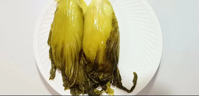 Squeeze and store: After two days, remove the cabbage and squeeze out excess water from the leaves. Pack the cabbage into a clean container, ensuring it's submerged in brine. Store in the refrigerator to halt further fermentation. You can eat after 2-3 days, but it can be kept longer.