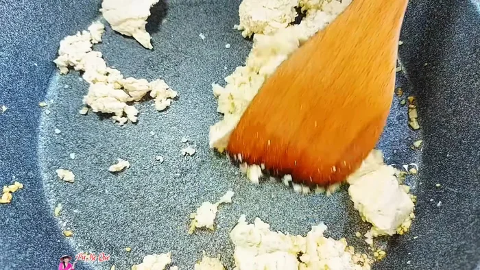 Squeeze tofu dry and stir-fry for about 2 minutes until slightly dry and fragrant.