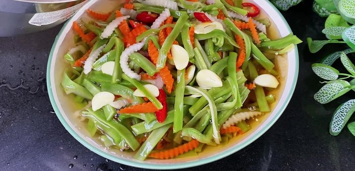 Pack the vegetable mixture into jars, pour in the cooled vinegar-sugar mixture, ensuring all ingredients are submerged.