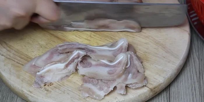 Cut the cooled pig's ears into thin, bite-sized pieces.