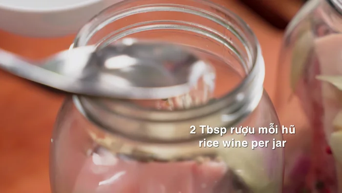 Add aromatics and wine: Add Cinnamon wine (or white wine) to each jar.