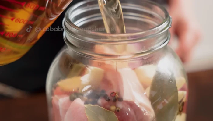 Pour in the cooled soaking water, ensuring the meat is fully submerged but leave some headspace in the jar for expansion during steaming.