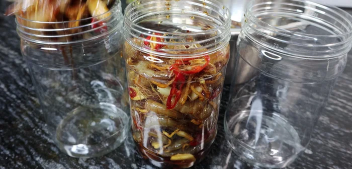 Pack the shrimp into sterilized jars, leaving some space at the top. If available, add guava or star fruit leaves.