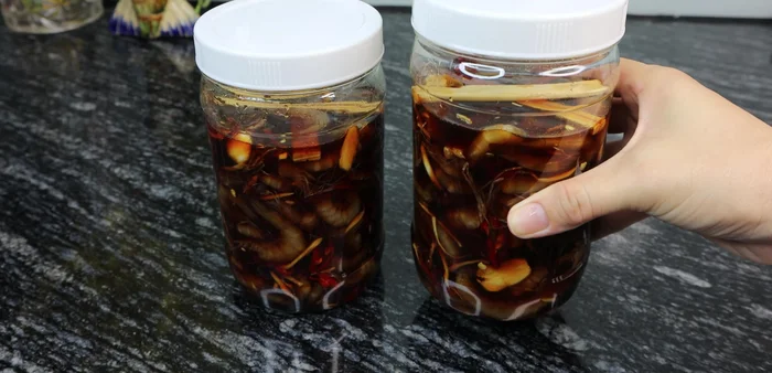 Let the jars sit in the sun for a few hours daily for about two weeks until the shrimp turn a deep red color.