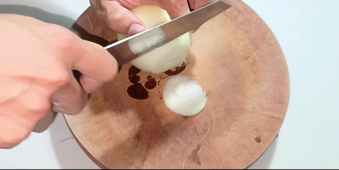 Prepare the onions, shallots, and ginger: Chop the onion into three pieces and then thinly slice four. Finely chop the shallots and ginger.